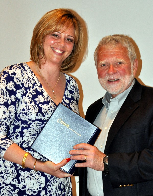 At the April luncheon, Kauffman presents an Unsung Hero award to Charlie Brown in recognition of his volunteering efforts above and beyond the call of duty.